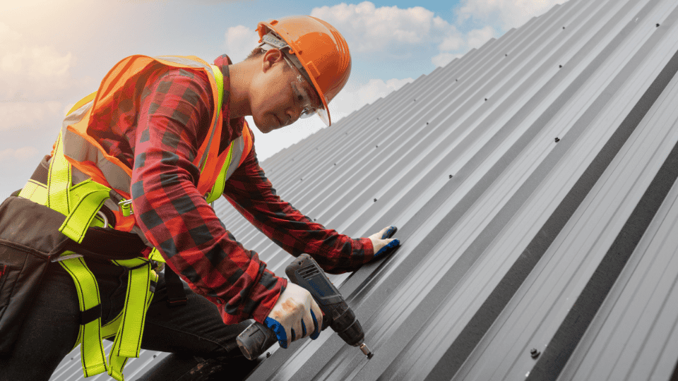 man fixing metal roof